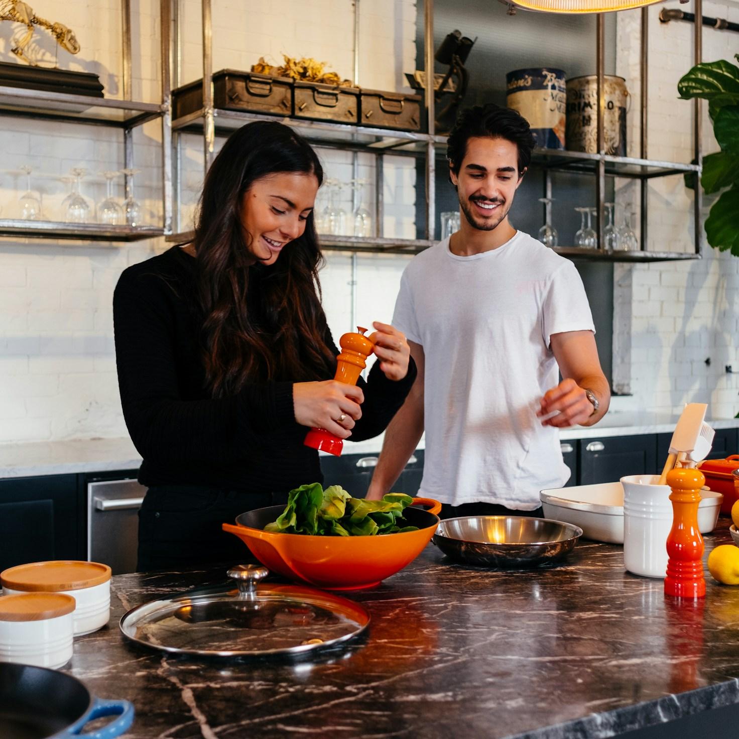 Community members collaborating in a modern kitchen space, sharing recipes and cooking techniques